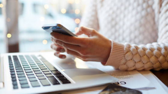 Girl-on-phone-with-in-front-of-labtop