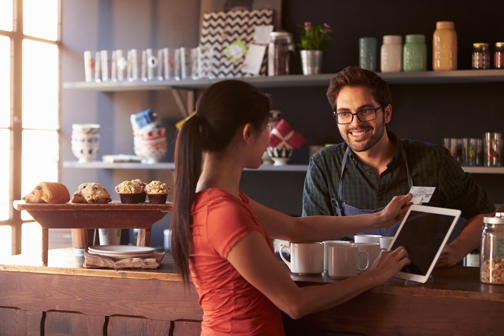 Customer swiping card on POS system of in a small business